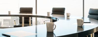 Attractive young mentor businesswoman conducts coaching in boardroom at company meeting. Confidence woman training corporate team at briefing. Young employee share thoughts standing at table.