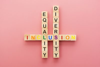 Inclusion, diversity and equality concept. Lgbtq abstract letters on wooden cubes over pink.