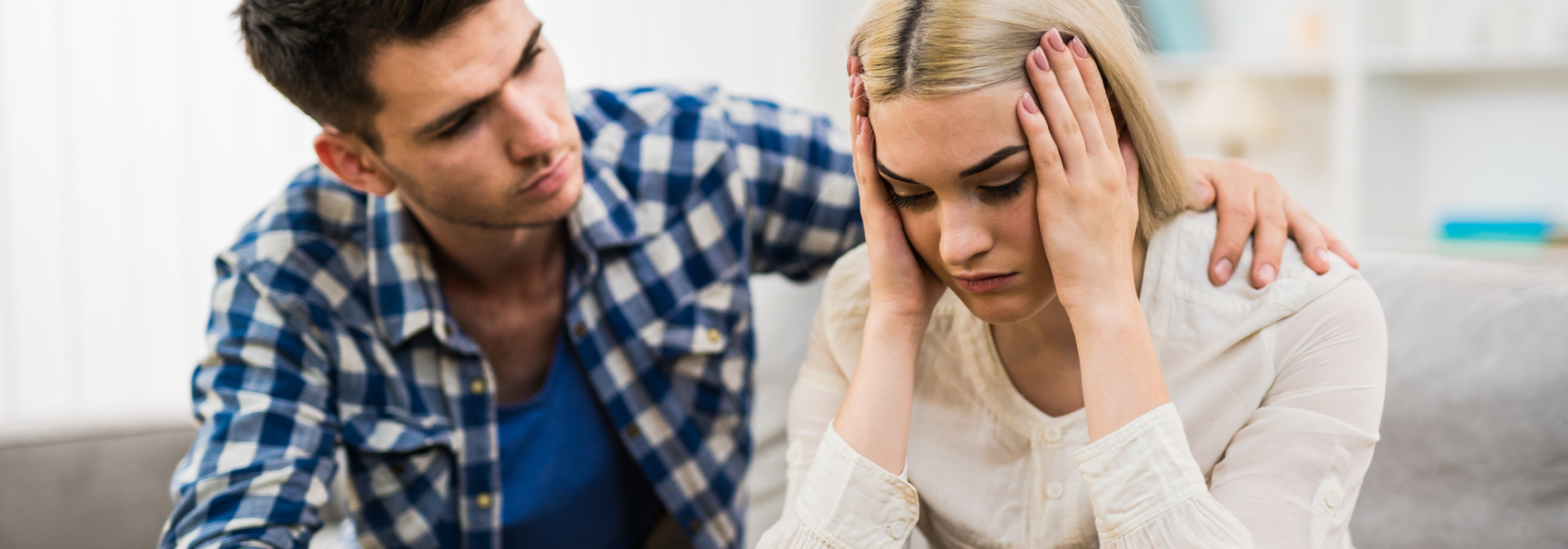 Man consoling a depressed woman