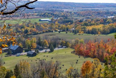 A country home is nestled amongst the Autumn colours as seen from Rattlesnake Point Conservation Area near Milton, Ontario.