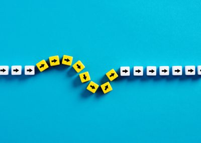 Flexibility and adaptation concept. Arrows on cubes following a flexible path.