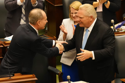 Ontario Premier Doug Ford, bottom right, shakes hands with Finance Minister Peter Bethlenfalvy, left, after he provided an economic update, which serves as a mini budget at Queen's Park, in Toronto, Wednesday, Oct. 30, 2024.